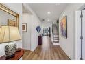 Inviting foyer with wood floors, staircase, and artwork, leading to the living areas at 4257 Freight St, Tucker, GA 30084