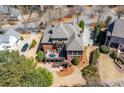 Stunning aerial view of the brick home with a screened porch and beautiful landscaping at 1037 Windermere Xing, Cumming, GA 30041