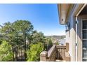 Balcony view showcases lush greenery and distant cityscape at 1037 Windermere Xing, Cumming, GA 30041