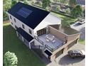 Aerial view of the stylish home with solar panels and a deck above the two-car garage at 2650 Roswell Rd, Marietta, GA 30062