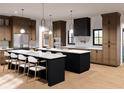 Spacious kitchen with modern stainless steel appliances, two large islands, and beautiful hardwood floors at 2650 Roswell Rd, Marietta, GA 30062