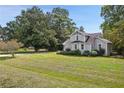 Spacious green lawn surrounds this charming two-story home with a neatly kept landscape at 1800 E Lake Rd, Mcdonough, GA 30252