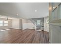 Open-concept living room boasts wood floors, recessed lighting, and a staircase leading to the upper level at 1800 E Lake Rd, Mcdonough, GA 30252