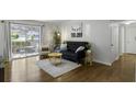 Inviting living room with modern decor, hardwood floors, and sliding door access to the outdoors at 2955 Seven Pines Se Ln # 203, Atlanta, GA 30339