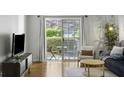 Open living room featuring hardwood floors, patio access, and comfortable seating at 2955 Seven Pines Se Ln # 203, Atlanta, GA 30339