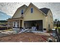 Two-story home with a two-car garage and covered porch, with some construction materials visible at 1243 Lakeside Overlook, Canton, GA 30114