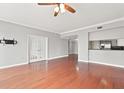 Spacious living room featuring hardwood floors, recessed lighting, and view into the kitchen at 195 14Th Ne St # 2402, Atlanta, GA 30309