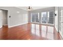 Bright living room with hardwood floors, ceiling fan, and large windows offering a city view at 195 14Th Ne St # 2402, Atlanta, GA 30309
