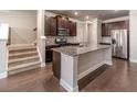 Stylish kitchen with granite counters, a large island, stainless steel appliances, and dark cabinetry at 2463 Quay Rdg, Lawrenceville, GA 30044