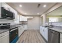 Well-lit kitchen featuring white cabinets, stainless steel appliances, and granite countertops at 54 Jean Ct, Hiram, GA 30141