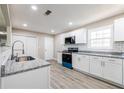 Stylish kitchen featuring gray-toned wood floors, modern appliances, and ample counter space at 54 Jean Ct, Hiram, GA 30141