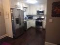 Modern kitchen with stainless steel appliances, white cabinets and tiled backsplash at 359 Cedar Ridge Trl, Lawrenceville, GA 30046
