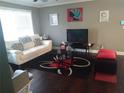 Inviting living room features wood floors, a white sofa and modern decorations at 359 Cedar Ridge Trl, Lawrenceville, GA 30046