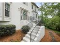 Close up of home's front entrance with bay window, painted stairs and iron handrail at 1945 Wenlok Ne Trl, Marietta, GA 30066