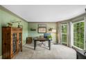 Well lit home office with decorative trim, large windows and neutral carpet at 1945 Wenlok Ne Trl, Marietta, GA 30066