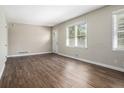 Bright living room featuring wood-look flooring, natural light from windows, and a neutral paint palette at 2564 Brentwood Rd, Decatur, GA 30032