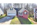 Charming single-Gathering home with a two-car garage, front lawn, and well-maintained landscaping at 4960 Markim Forest Ln, Sugar Hill, GA 30518