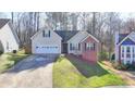 Charming single-Gathering home with a two-car garage, front lawn, and well-maintained landscaping at 4960 Markim Forest Ln, Sugar Hill, GA 30518