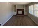 Cozy living room features a brick fireplace, built-in shelving, and new flooring at 2703 Rainbow Forest Dr, Decatur, GA 30034