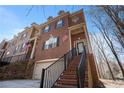 Beautiful brick townhome with attached garage, front porch entry and landscaped surroundings on a sunny day at 600 Jardin Ct # 48, Alpharetta, GA 30022