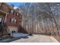 Brick townhome with attached garage, front porch entry and landscaped surroundings at 600 Jardin Ct # 48, Alpharetta, GA 30022