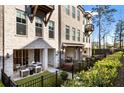 Lovely covered patio with comfortable seating and a view of the landscaped backyard at 520 Clover Ln, Alpharetta, GA 30009