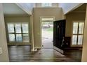 Bright foyer with wood floors and views into the rooms with large windows flanking the door at 5815 P.W.A. Dr, Cumming, GA 30041