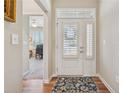 Bright entryway featuring hardwood floors, white front door with sidelight, and decorative rug at 67 Narrowleaf Ln, Dallas, GA 30157