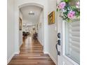 Inviting hallway with hardwood floors, neutral walls, arched entryway, and charming decor at 67 Narrowleaf Ln, Dallas, GA 30157