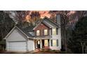 Charming two-story home with white siding, brick accents, black shutters, and well-maintained landscaping at 802 Eagle Glen Xing, Woodstock, GA 30189