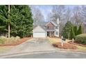 Charming home with a two car garage, well-maintained lawn, and mature trees at 802 Eagle Glen Xing, Woodstock, GA 30189