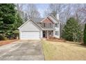 Beautiful home with a two car garage, driveway, lush lawn, and welcoming front entrance at 802 Eagle Glen Xing, Woodstock, GA 30189