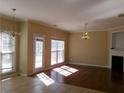 Bright living room featuring hardwood floors, elegant lighting, and a cozy fireplace at 1211 Saxony Se Dr, Conyers, GA 30013