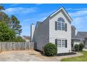 Side angle of a gray two-story home with fresh landscaping, driveway and privacy fence at 16 Montclair Ct, Cartersville, GA 30121