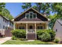 Charming bungalow featuring a cozy front porch, shingled gable, and well-maintained landscaping at 2628 White Oak Dr, Decatur, GA 30032