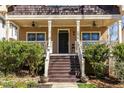 A cozy covered front porch with ceiling fans is perfect for relaxing and enjoying the outdoors at 2628 White Oak Dr, Decatur, GA 30032