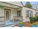 Cozy side porch with seating, shutters, and potted plants enhancing the home's charm at 49 Wyman Se St, Atlanta, GA 30317