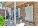 Inviting front porch with a 'welcome' mat, flowers, and seating that enhances curb appeal at 3455 Flycatcher Way, Duluth, GA 30097