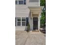 Close-up of the entrance with a cozy porch, dark door, and neat landscaping at 1433 Carroll Drive Nw, Unit #3, Atlanta, GA 30318