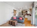 Open-concept living area flowing into a modern kitchen with hardwood floors and natural light at 1433 Carroll Drive Nw, Unit #3, Atlanta, GA 30318