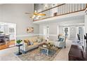 Open living room with vaulted ceiling, large windows, and a cozy seating area at 6009 Wyndham Woods Dr, Powder Springs, GA 30127
