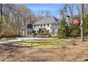 Attractive home boasts mature landscaping, manicured lawn, an American flag, and a welcoming exterior at 4578 Polo Se Ln, Atlanta, GA 30339