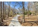 Beautiful home nestled among trees, featuring a long driveway leading to a stately residence at 4578 Polo Se Ln, Atlanta, GA 30339