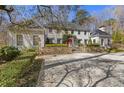 Charming two-story home with landscaped front yard, stone accents, and a welcoming arched entrance at 4578 Polo Se Ln, Atlanta, GA 30339