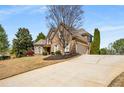 Lovely home with lush lawn, wide driveway and mature trees in a desirable neighborhood at 5136 Heron Bay Blvd, Locust Grove, GA 30248