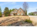 Beautifully landscaped lawn leads to a lovely brick home with an inviting entrance at 5136 Heron Bay Blvd, Locust Grove, GA 30248