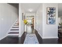 Bright foyer with hardwood floors, staircase, neutral walls, and view into other living spaces at 880 Hillary Ln, Lawrenceville, GA 30043