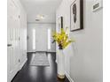 Welcoming foyer with hardwood floors, art accents, white walls, and a glimpse of the front door at 880 Hillary Ln, Lawrenceville, GA 30043