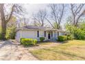 A cozy one story home with manicured front bushes and a side driveway at 2062 Whites Mill Rd, Decatur, GA 30032