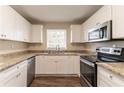 Modern kitchen featuring stainless steel appliances, granite countertops, and white cabinetry at 2062 Whites Mill Rd, Decatur, GA 30032
